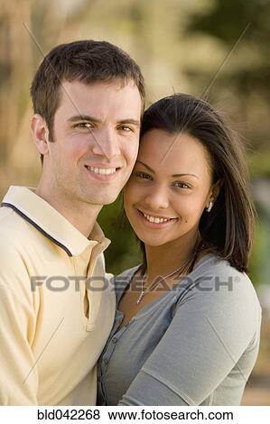 Hispanic couple hugging View Large Photo Image Stock Photo - Hispanic couple hugging. Fotosearch