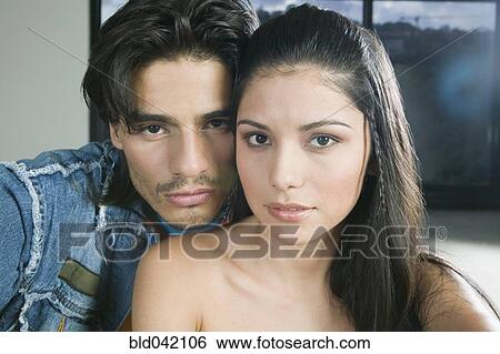 Stock Photograph - Hispanic couple hugging. Fotosearch