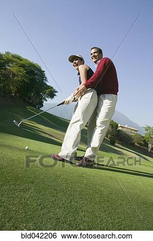 Hispanic couple playing golf View Large Photo Image Stock Photograph - Hispanic couple playing golf. Fotosearch