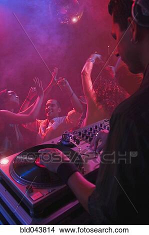 Picture - Hispanic dj playing at nightclub. Fotosearch