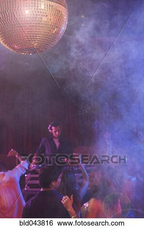 Hispanic dj playing at nightclub View Large Photo Image Stock Photograph - Hispanic dj playing at nightclub. Fotosearch