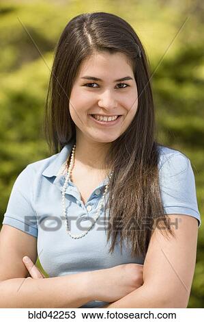 Hispanic girl with arms crossed View Large Photo Image Stock Image - Hispanic girl with arms crossed. Fotosearch