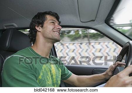 Hispanic man driving car View Large Photo Image Stock Photo - Hispanic man driving car. Fotosearch