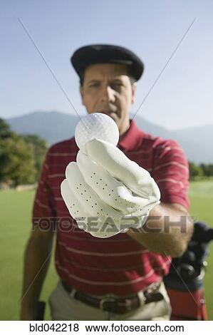 Hispanic man holding golf ball View Large Photo Image Stock Photo - Hispanic man holding golf ball. Fotosearch