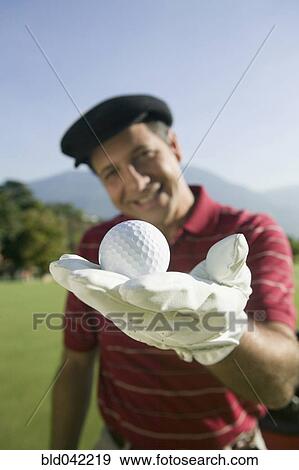 Hispanic man holding golf ball View Large Photo Image Stock Photo - Hispanic man holding golf ball. Fotosearch