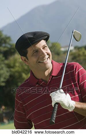 Hispanic man holding golf club over shoulder View Large Photo Image Stock Photograph - Hispanic man holding golf club over shoulder. Fotosearch