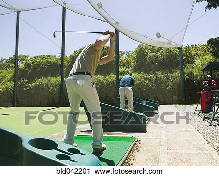 Stock Image - Hispanic man playing golf. Fotosearch