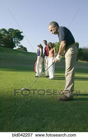 Stock Photo - Hispanic man playing golf. Fotosearch