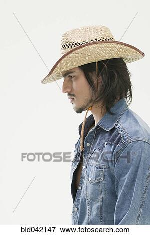Stock Photo - Hispanic man wearing cowboy hat. Fotosearch