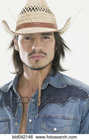 Stock Photograph - Hispanic man wearing cowboy hat. Fotosearch