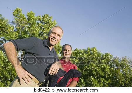 Stock Photography - Hispanic men with golf clubs. Fotosearch