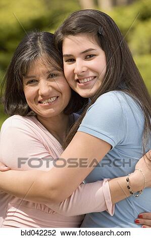 Hispanic mother and daughter hugging View Large Photo Image Stock Image - Hispanic mother and daughter hugging. Fotosearch