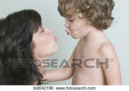 Stock Photograph - Hispanic mother and son blowing kisses. Fotosearch