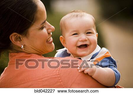 Hispanic mother holding baby View Large Photo Image Stock Photo - Hispanic mother holding baby. Fotosearch