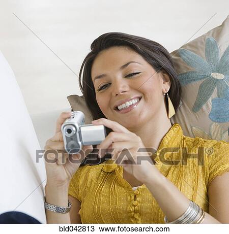 Stock Image - Hispanic woman looking at video camera. Fotosearch