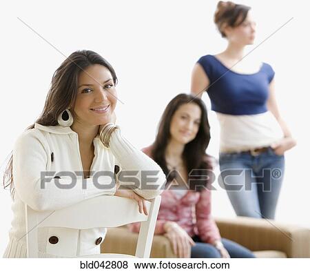 Stock Photo - Hispanic woman with friends in background. Fotosearch