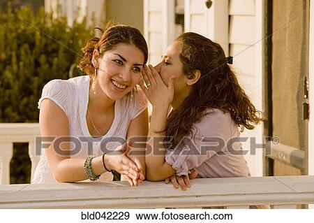 Hispanic women telling secret View Large Photo Image Stock Photo - Hispanic women telling secret. Fotosearch