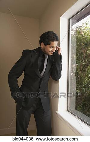 Indian businessman looking out window View Large Photo Image Stock Photograph - Indian businessman looking out window. Fotosearch