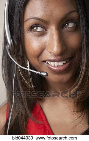Stock Photo - Indian businesswoman wearing headset. Fotosearch