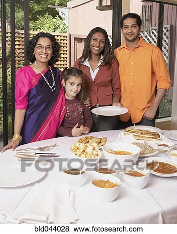 Stock Photo - Indian family at dinner table. Fotosearch