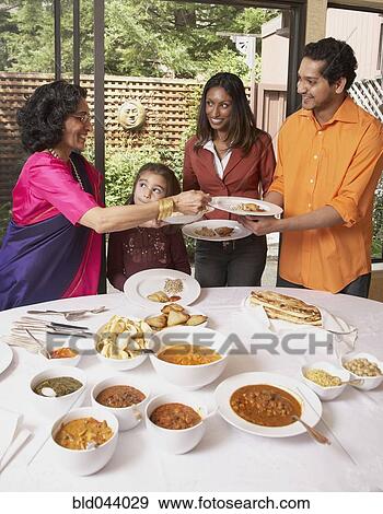 Indian family at dinner table View Large Photo Image Stock Photo - Indian family at dinner table. Fotosearch