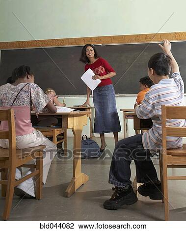 Indian female teacher handing back papers View Large Photo Image Stock Image - Indian female teacher handing back papers. Fotosearch