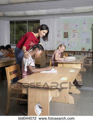 Indian female teacher helping student View Large Photo Image Stock Image - Indian female teacher helping student. Fotosearch