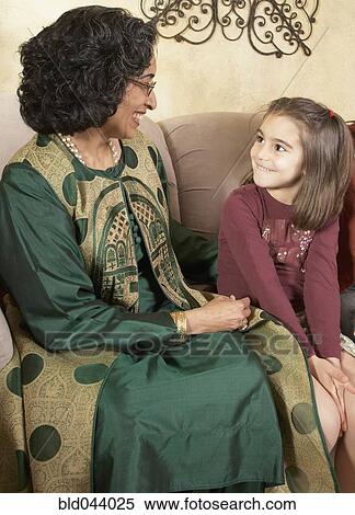 Stock Photography - Indian grandmother and granddaughter smiling at each other. Fotosearch