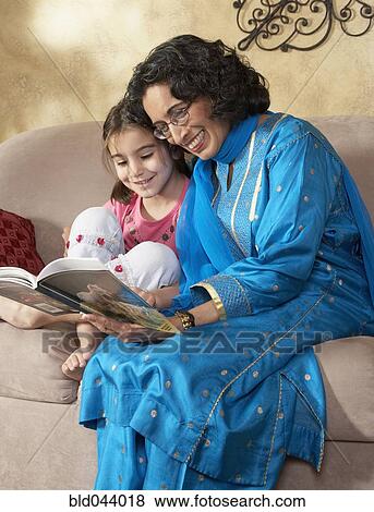 Stock Photo - Indian grandmother reading to granddaughter. Fotosearch