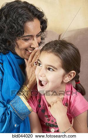 Indian grandmother telling granddaughter a secret View Large Photo Image Stock Image - Indian grandmother telling granddaughter a secret. Fotosearch