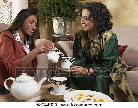 Indian mother and adult daughter having tea View Large Photo Image Stock Image - Indian mother and adult daughter having tea. Fotosearch