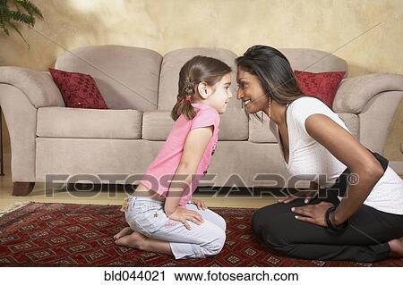 Indian mother and daughter smiling at each other View Large Photo Image Stock Image - Indian mother and daughter smiling at each other. Fotosearch