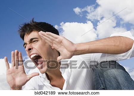 Stock Photo - Man yelling with hands up. Fotosearch