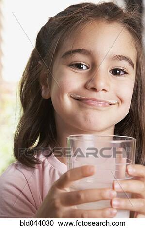 Stock Image - Middle Eastern girl drinking milk. Fotosearch