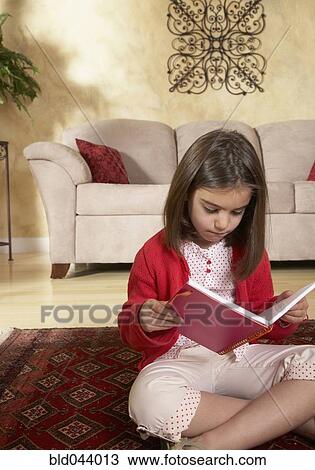 Middle Eastern girl reading on floor View Large Photo Image Stock Image - Middle Eastern girl reading on floor. Fotosearch