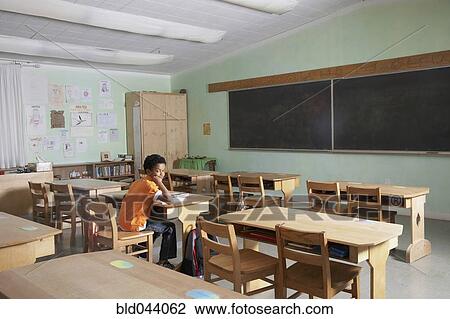 Mixed Race boy in empty classroom View Large Photo Image Stock Image - Mixed Race boy in empty classroom. Fotosearch