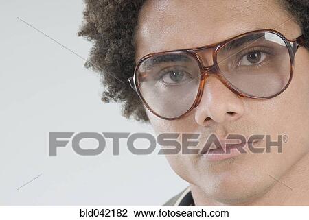 Stock Image - Mixed Race man wearing sunglasses. Fotosearch
