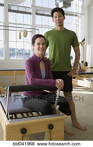 Stock Photo - Multi-ethnic business partners in exercise studio. Fotosearch