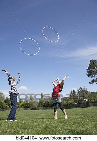 Multi-ethnic girls playing with hula hoops View Large Photo Image Picture - Multi-ethnic girls playing with hula hoops. Fotosearch