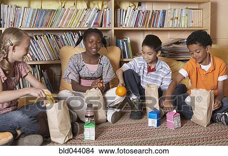 Picture - Multi-ethnic school children eating lunch. Fotosearch
