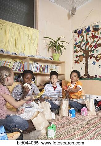 Stock Photography - Multi-ethnic school children eating lunch. Fotosearch