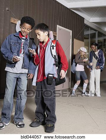 Stock Photo - Multi-ethnic school children listening to mp3 players. Fotosearch