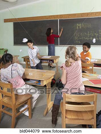 Multi-ethnic students acting up in class View Large Photo Image Stock Photo - Multi-ethnic students acting up in class. Fotosearch