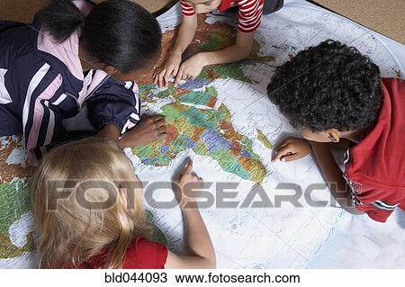 Multi-ethnic students looking at world map View Large Photo Image Stock Image - Multi-ethnic students looking at world map. Fotosearch