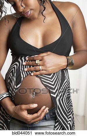 Pregnant African American woman with hands on belly View Large Photo Image Stock Image - Pregnant African American woman with hands on belly. Fotosearch