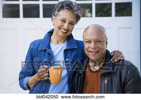 Stock Image - Senior African American couple hugging. Fotosearch