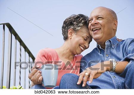 Stock Image - Senior African American couple hugging . Fotosearch