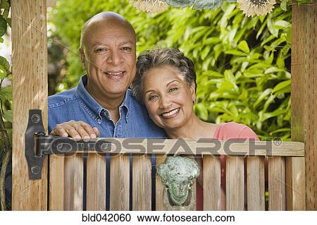 Senior African American couple looking over gate View Large Photo Image Stock Image - Senior African American couple looking over gate. Fotosearch