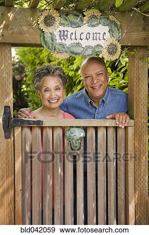 Senior African American couple looking over gate View Large Photo Image Stock Photo - Senior African American couple looking over gate. Fotosearch