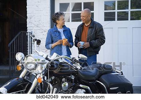 Senior African American couple next to motorcycle View Large Photo Image Stock Photo - Senior African American couple next to motorcycle. Fotosearch